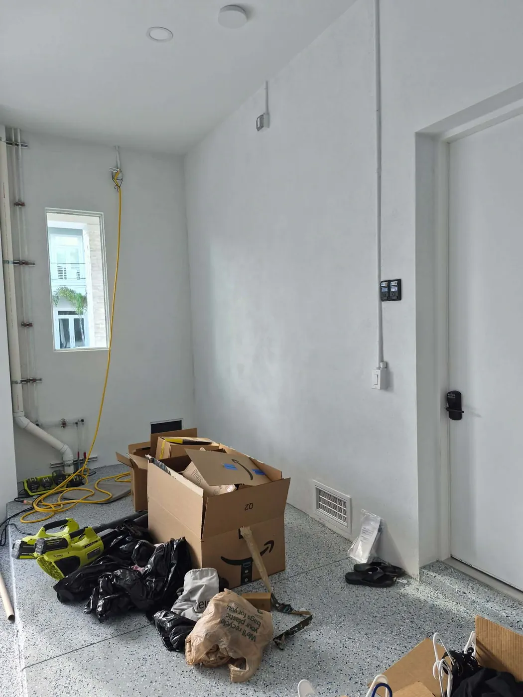 Custom garage cabinets before in Ozona, FL — belongings stored on the floor