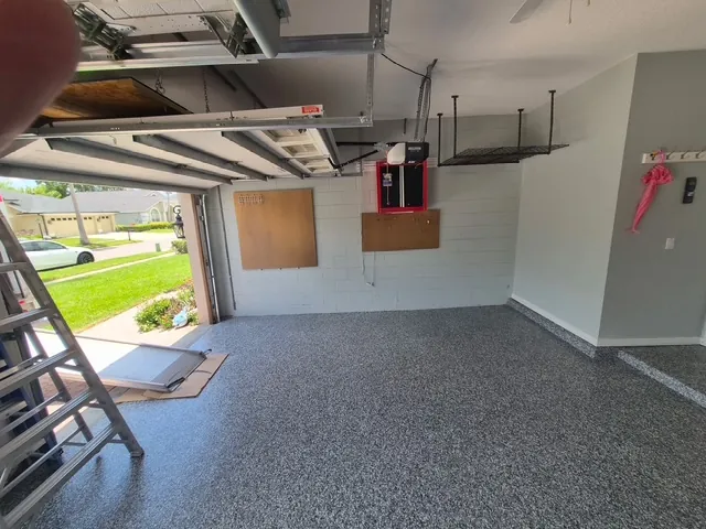 Garage cleanout after in Tampa, FL — cleared, reorganized, and coated