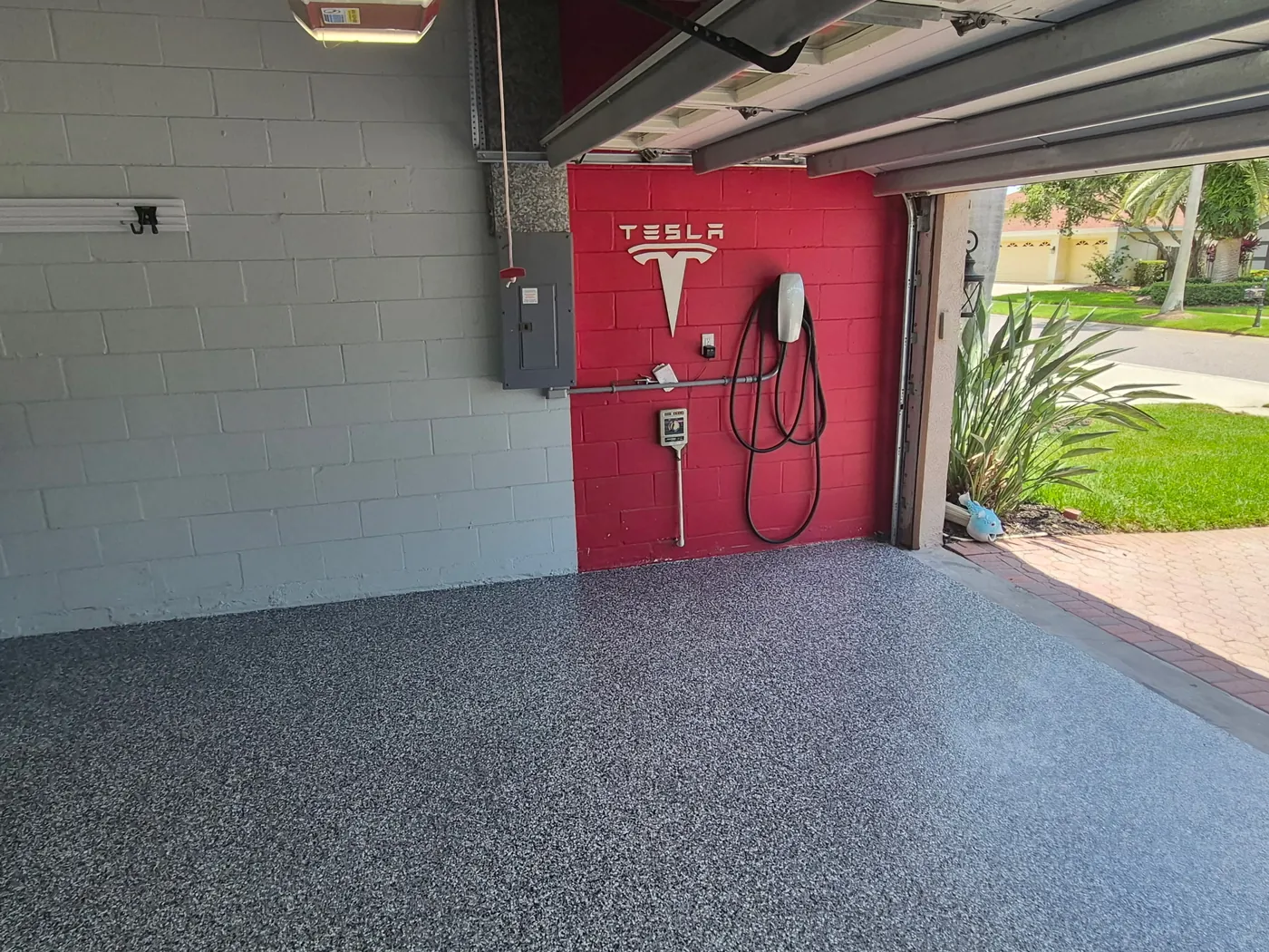 Garage floor coating after in Tampa, FL — gray flake polyaspartic floor to the driveway edge